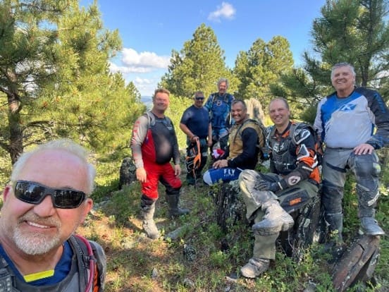 A group of people standing on top of a hill.