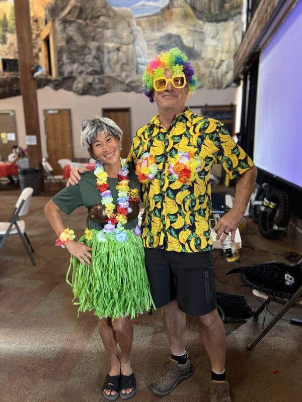 Couple in Hawaiian costumes at party.