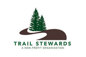 A trail stewards logo with trees and a road.